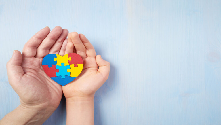 Father,And,Autistic,Son,Hands,Holding,Jigsaw,Puzzle,Heart,Shape.
